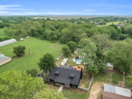 Birds-eye view of property with expansive living space as well as natural treed space for hiking and exploring