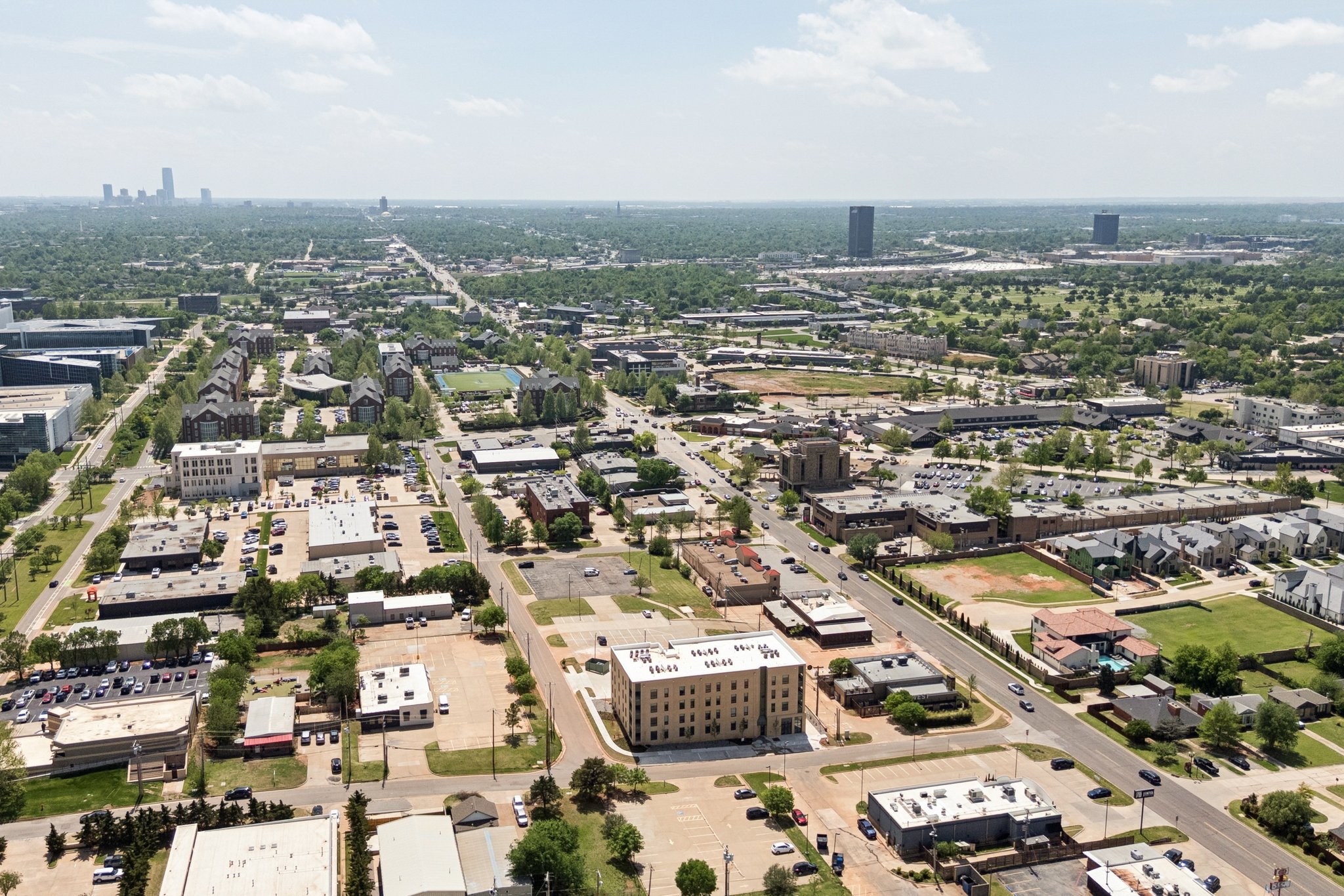 Drone view over the neighborhood toward the Oklahoma City skyline