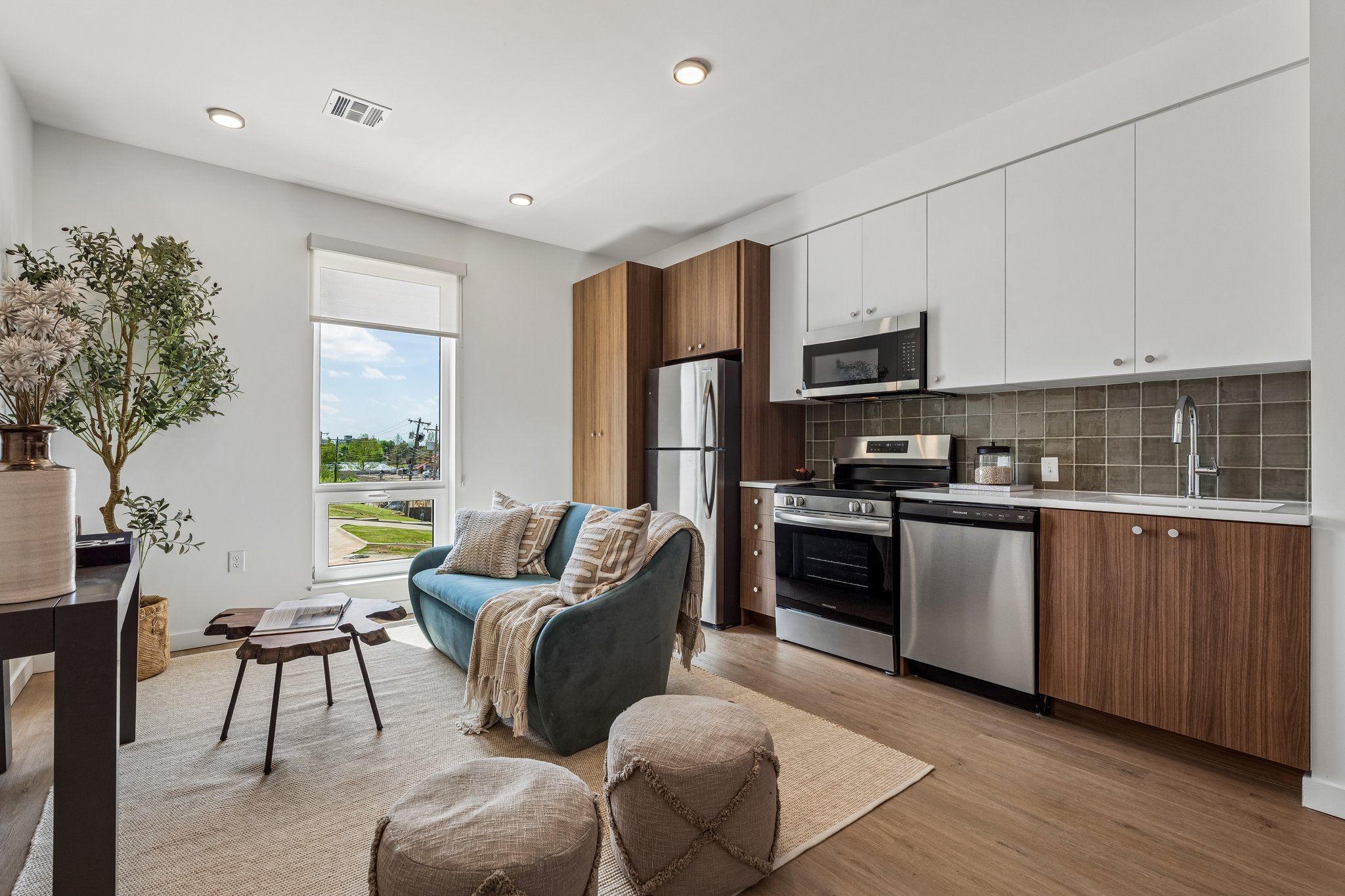 Open-plan model unit with the living area flowing into the kitchen