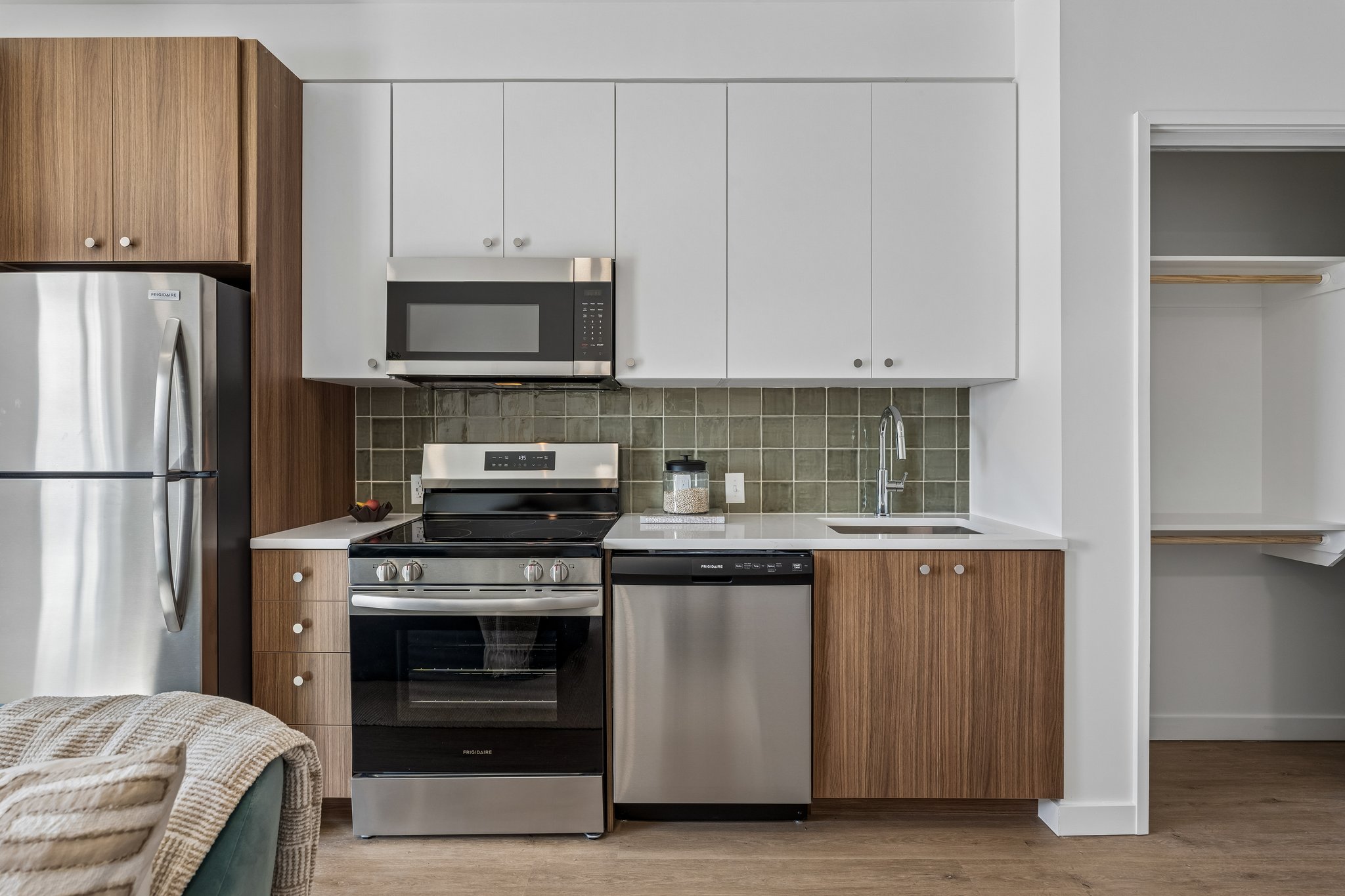 Second floor plan kitchen with white cabinets and a green tile backsplash