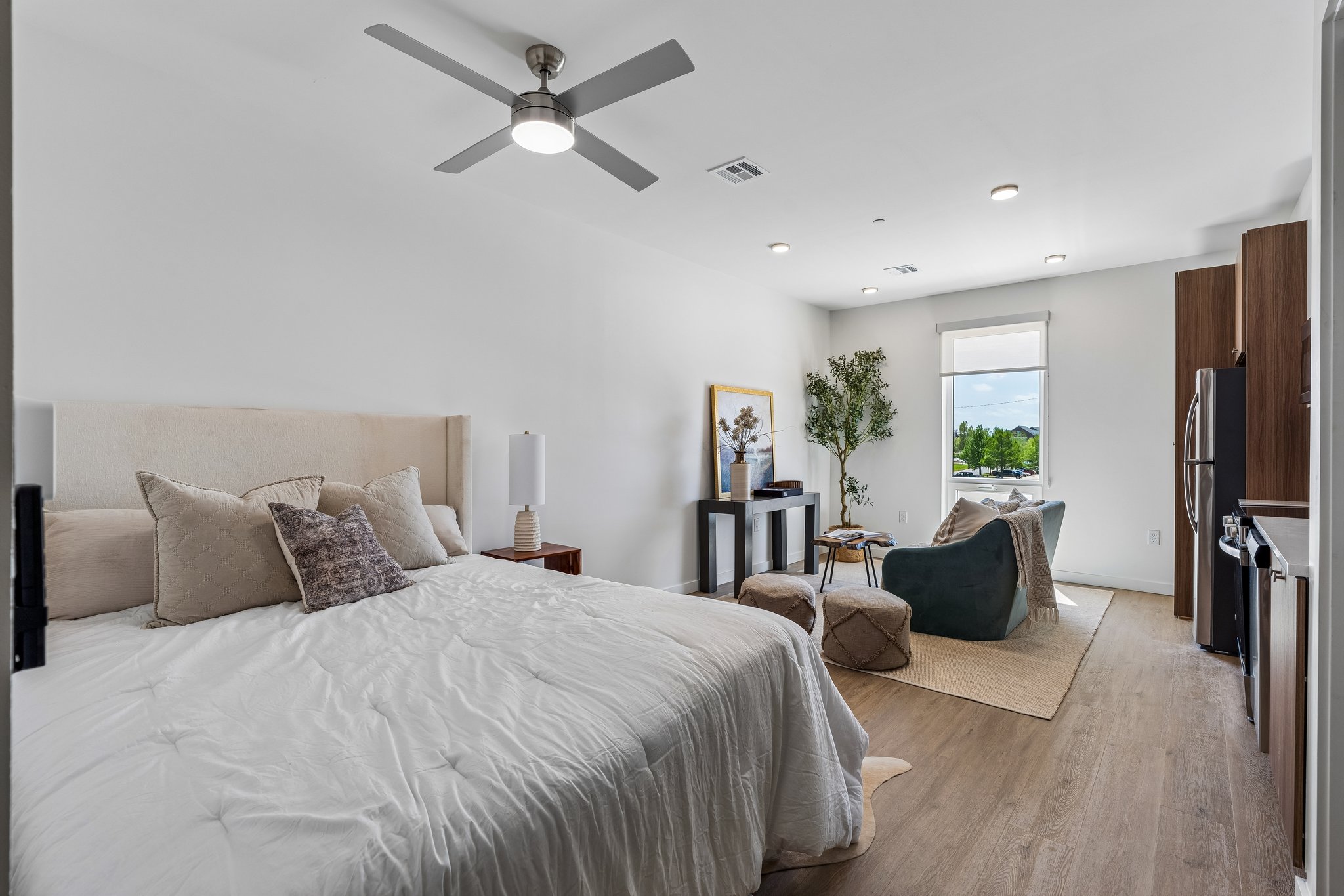 Second floor plan bedroom with a made bed and a reading chair