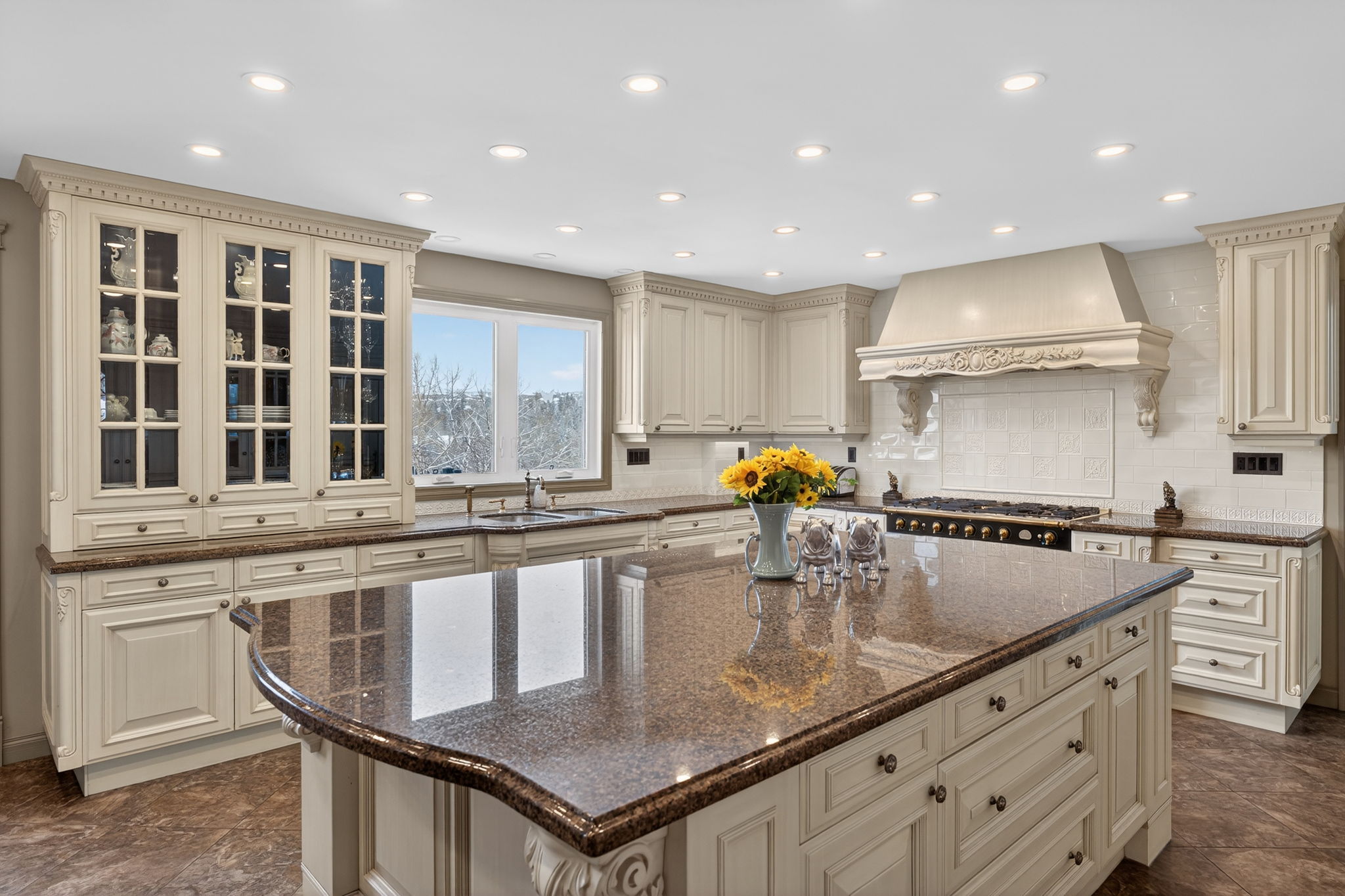 Updated kitchen with granite island and gas range