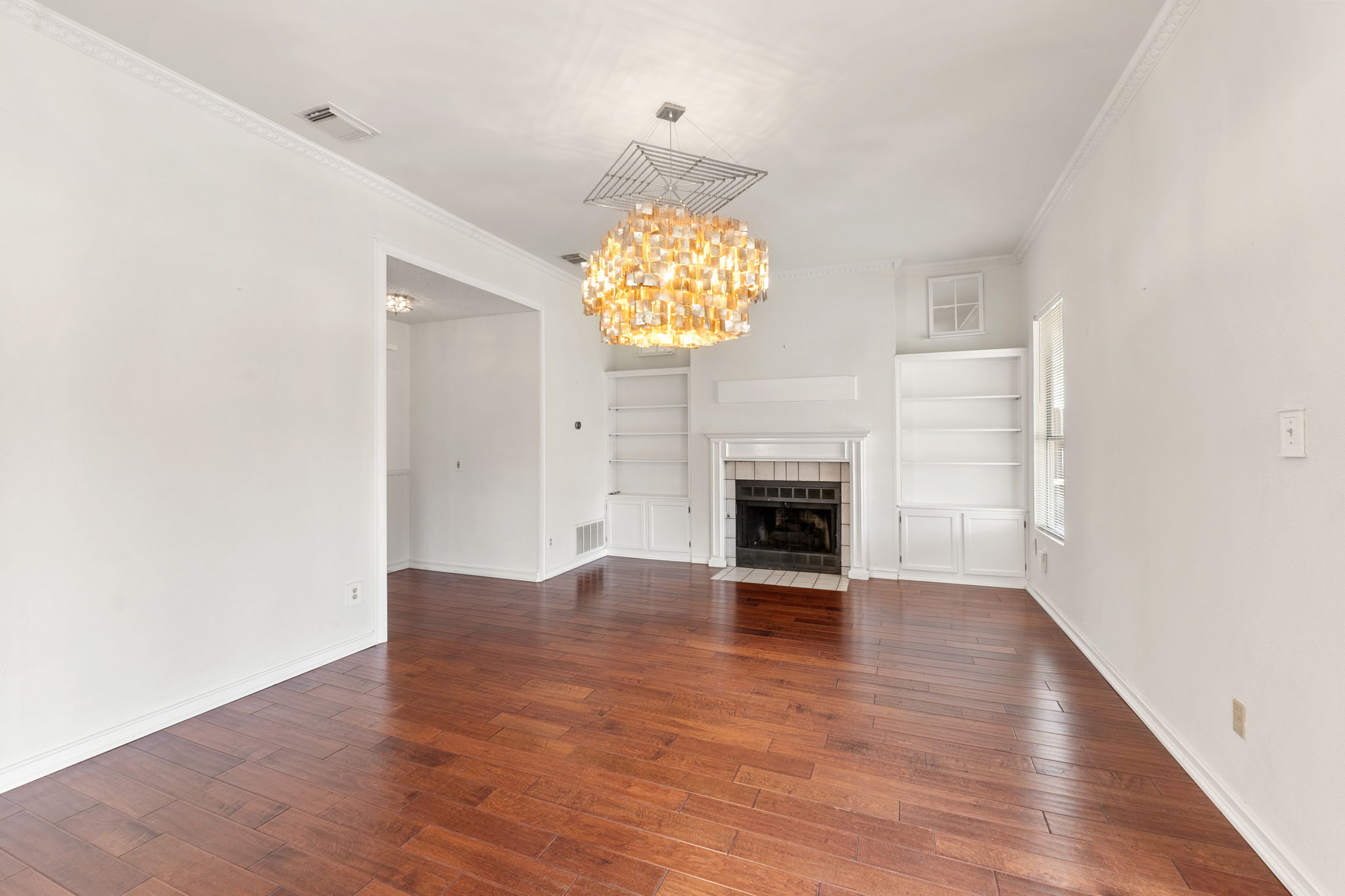 With a touch of fancifulness, the family room is set  with built ins and a comfortable fireplace.