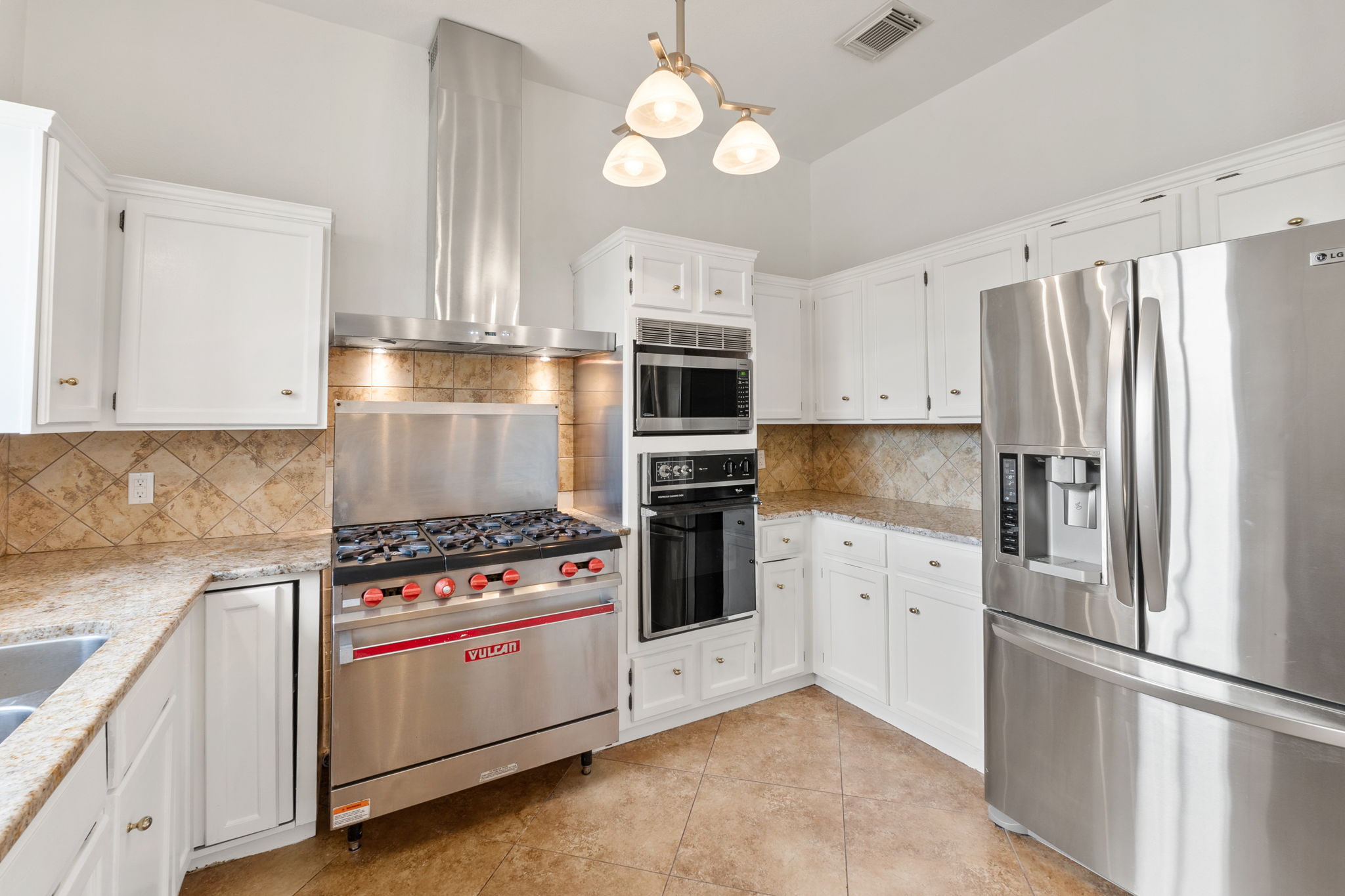 Plenty of cabinets and space for storage in the kitchen area.