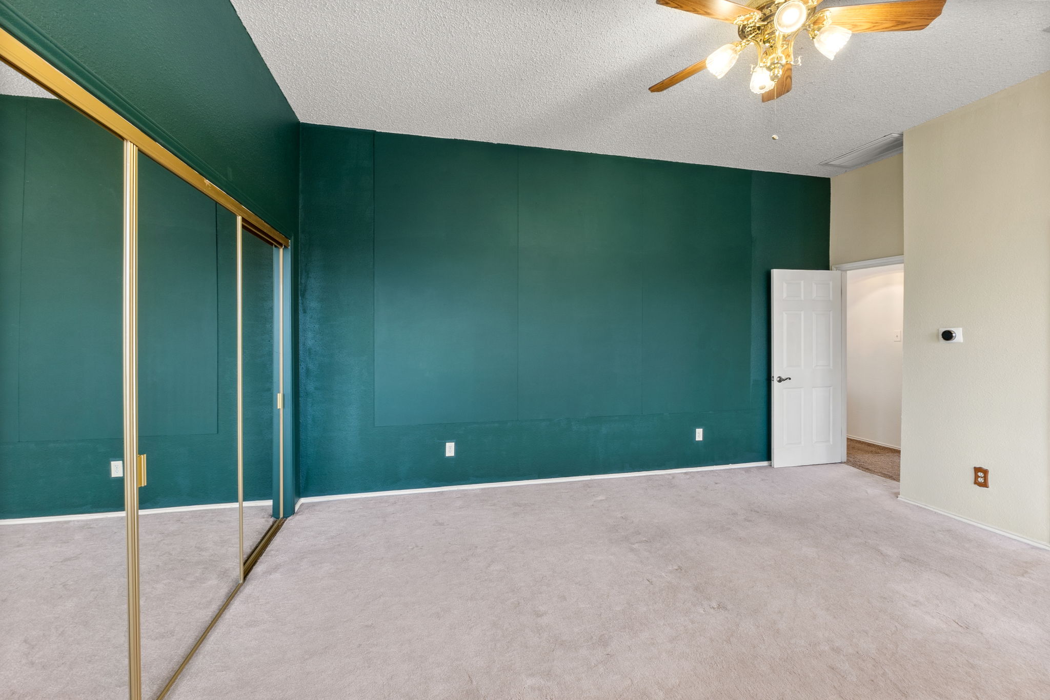 Deep, rich forest green walls - you can love them or paint them, but they offer an opportunity to bring the character into this room. Paint is easy, but the room is large enough for a king sized bed and 2 nightstands.