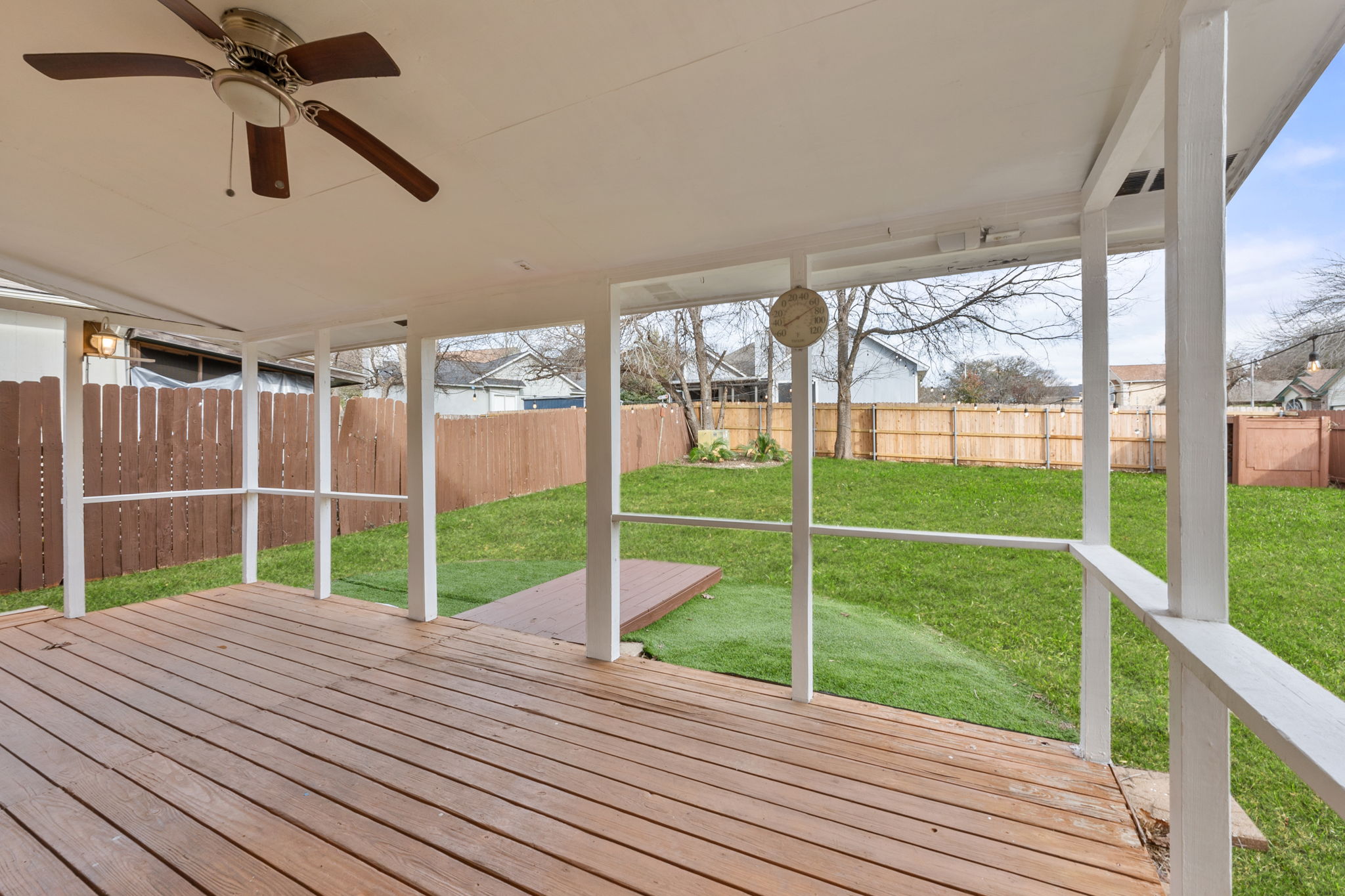 Lush backyard when it is spring, but the covered back patio is year round! Note: grass is digitally enhanced.