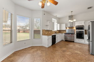 The bay window setting allows a wonderful view of the backyard while enjoying breakfast in this nook.