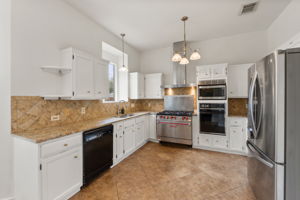 The carmel colored granite and the tile backsplash is ideal for clean up!