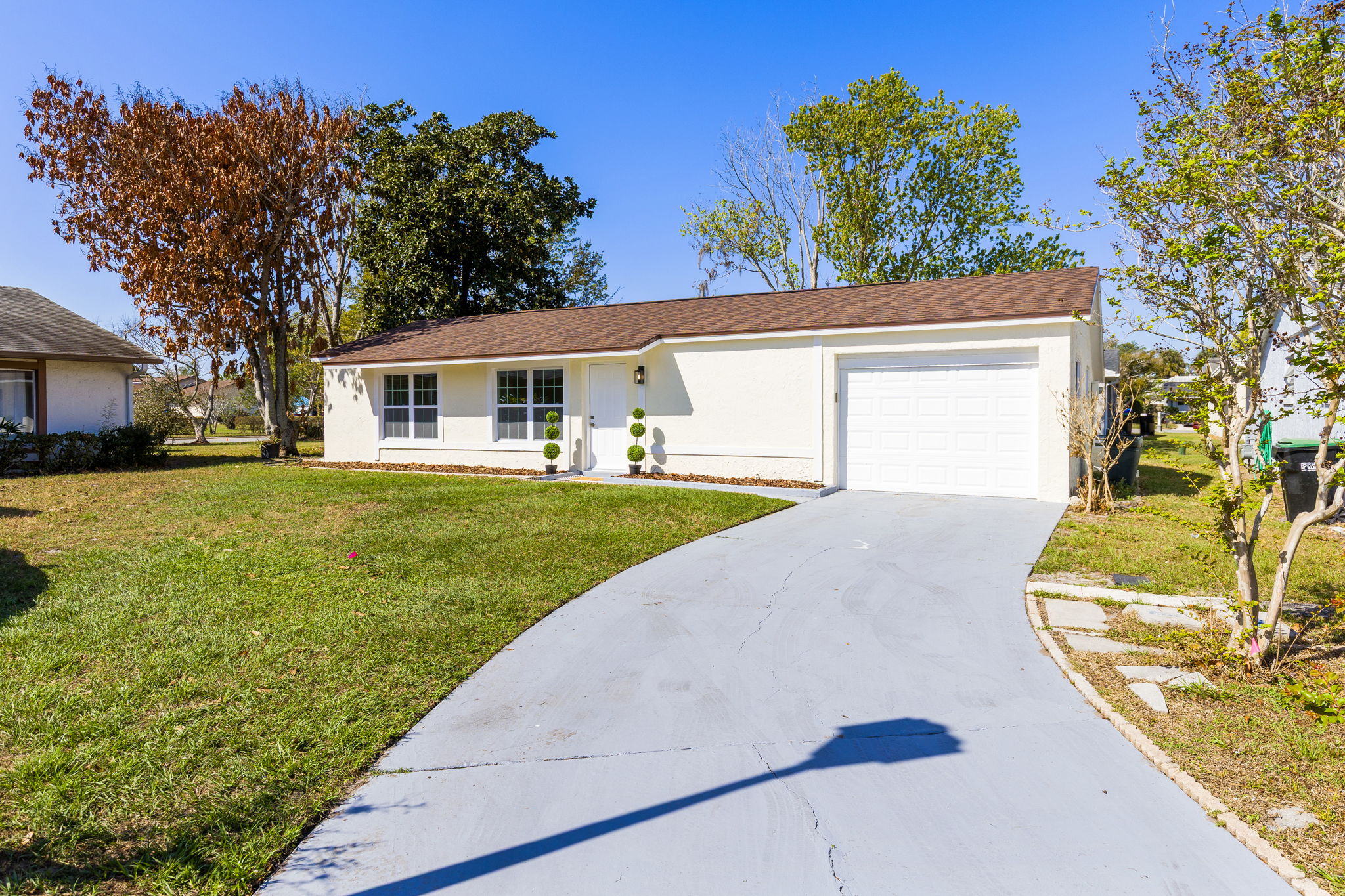 Welcoming front exterior with extended driveway.