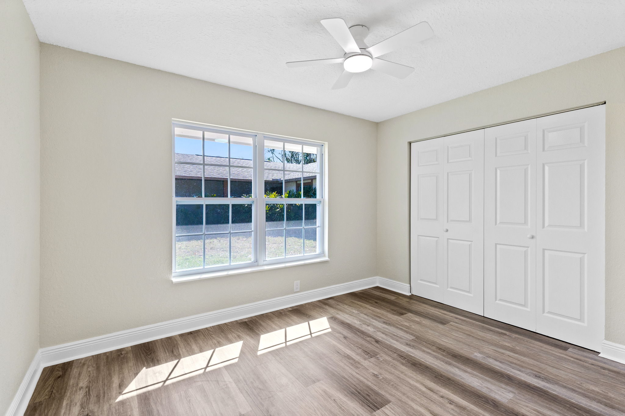 Secondary bedroom filled with natural light.