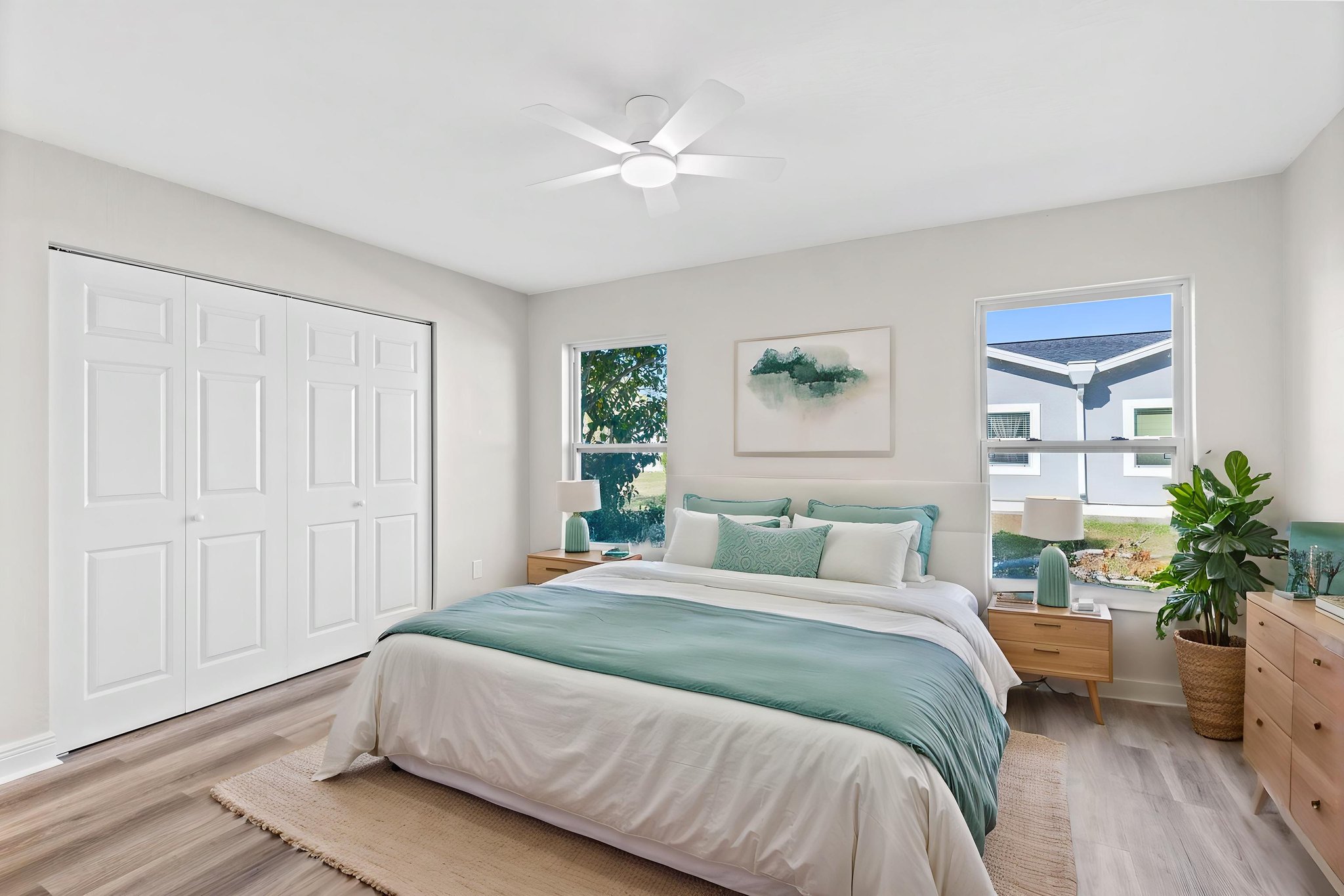Primary bedroom virtually staged to showcase comfortable furniture placement.