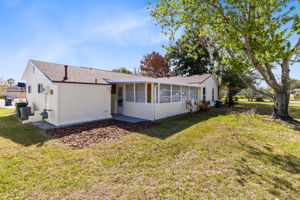 Rear exterior of the home with outdoor space.