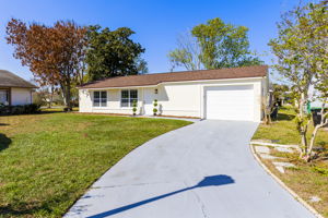 Welcoming front exterior with extended driveway.