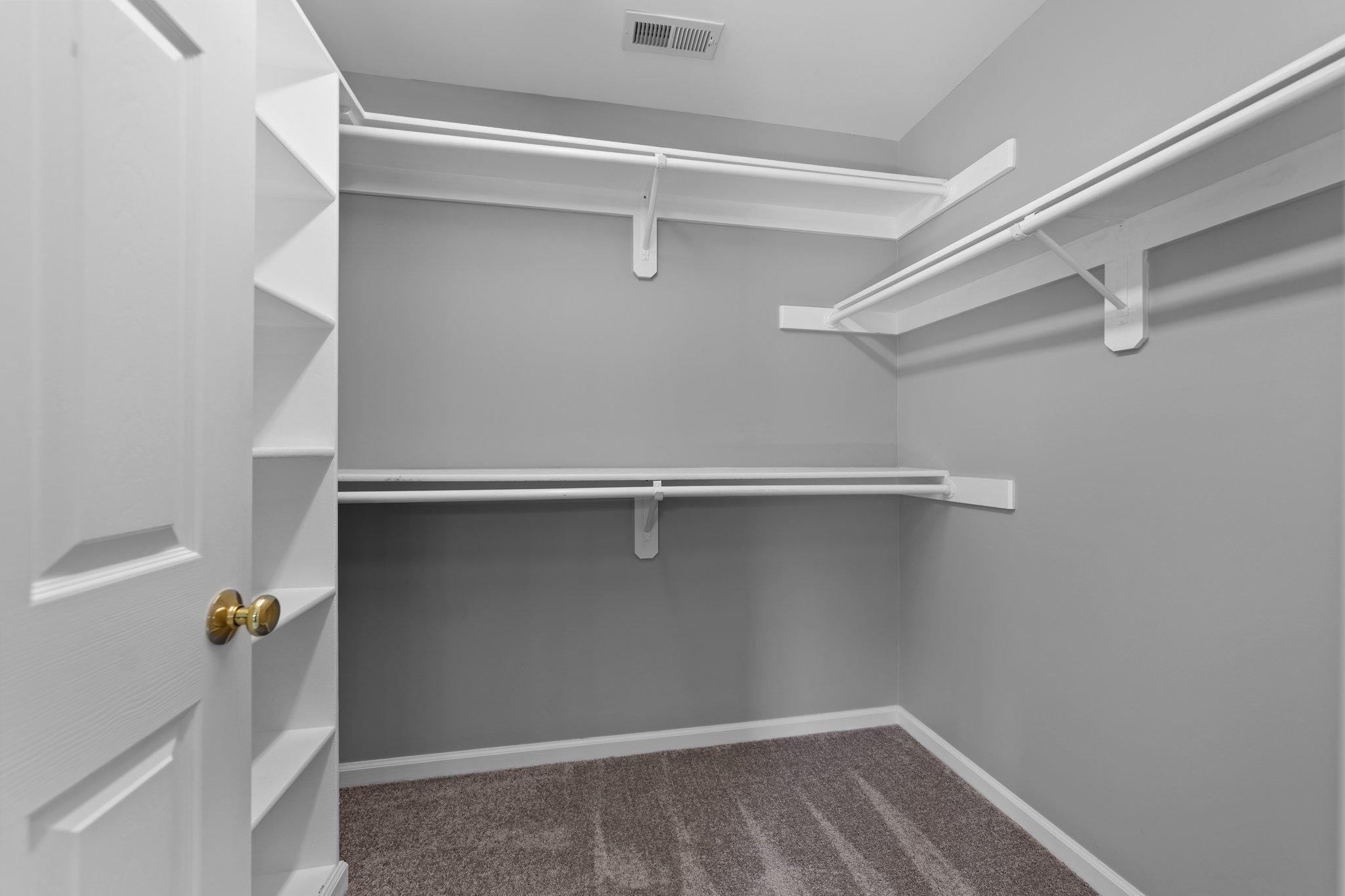 Walk-in closet with wood shelving
