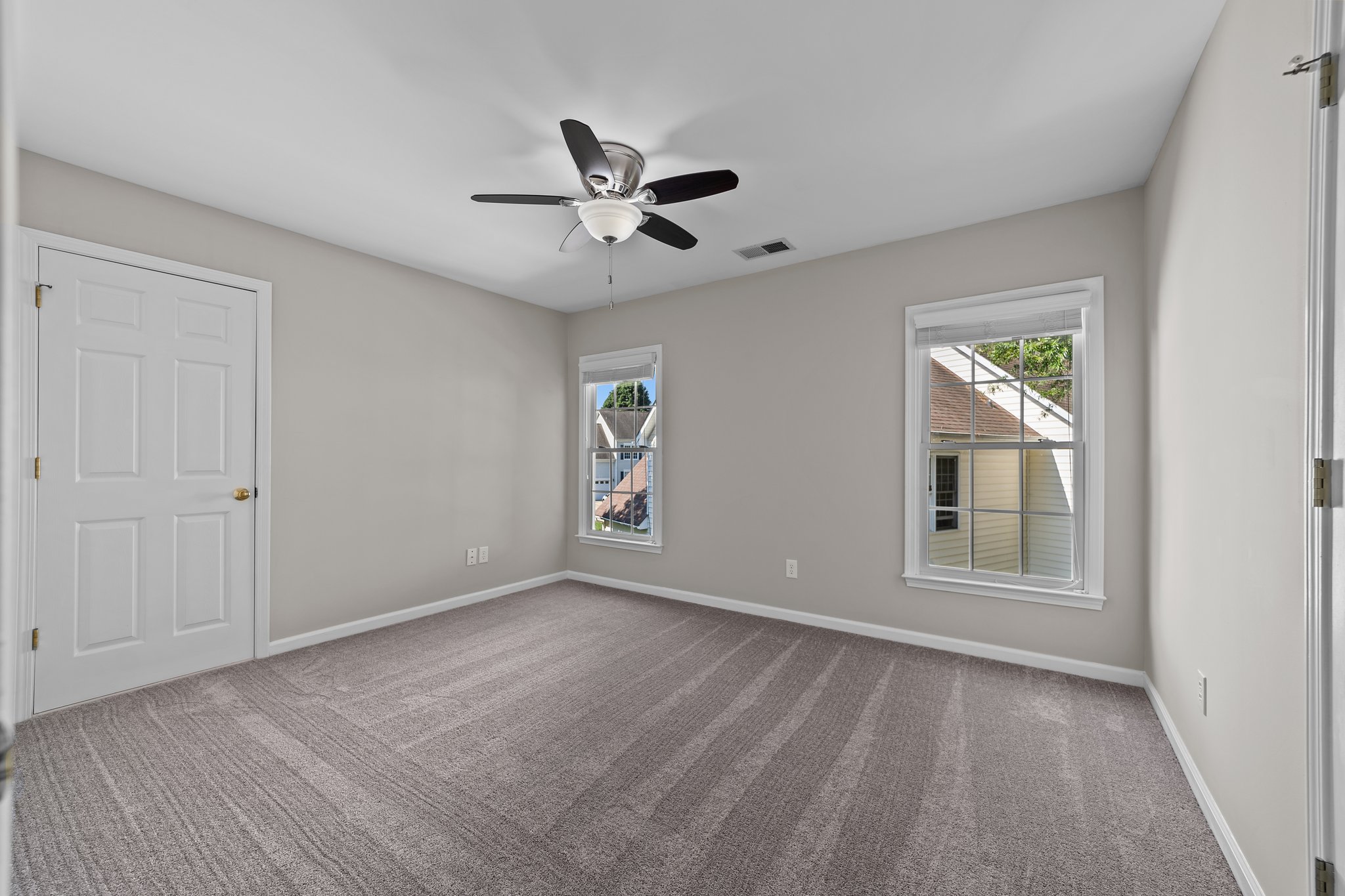 Bedroom 3 with ceiling fan and walk-in attic