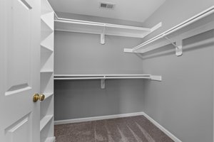 Walk-in closet with wood shelving