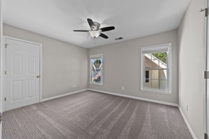 Bedroom 3 with ceiling fan and walk-in attic