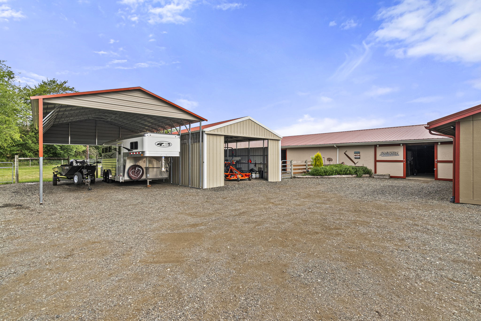 Three additional covered parking structures provide exceptional space for trailers, equipment, recreational vehicles, or everyday storage