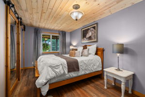 Additional main-floor bedroom featuring a beautiful new tongue-and-groove ceiling.