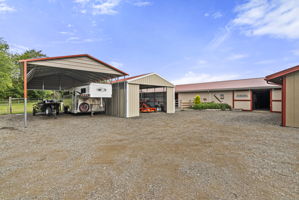 Three additional covered parking structures provide exceptional space for trailers, equipment, recreational vehicles, or everyday storage