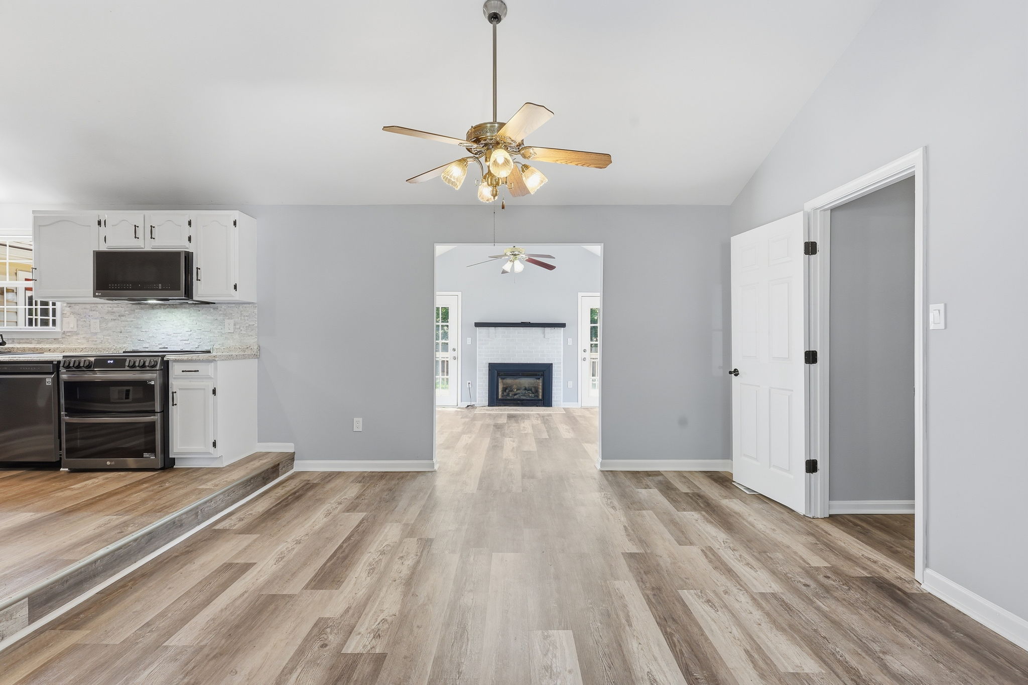 Dining room with view of elevated kitchen and sunroom