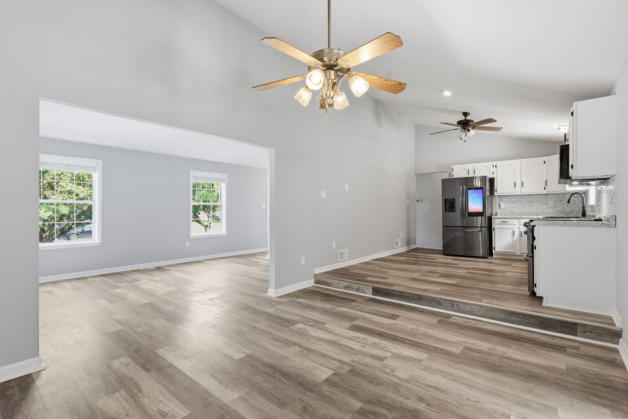 View of elevated kitchen, dining room, and living room