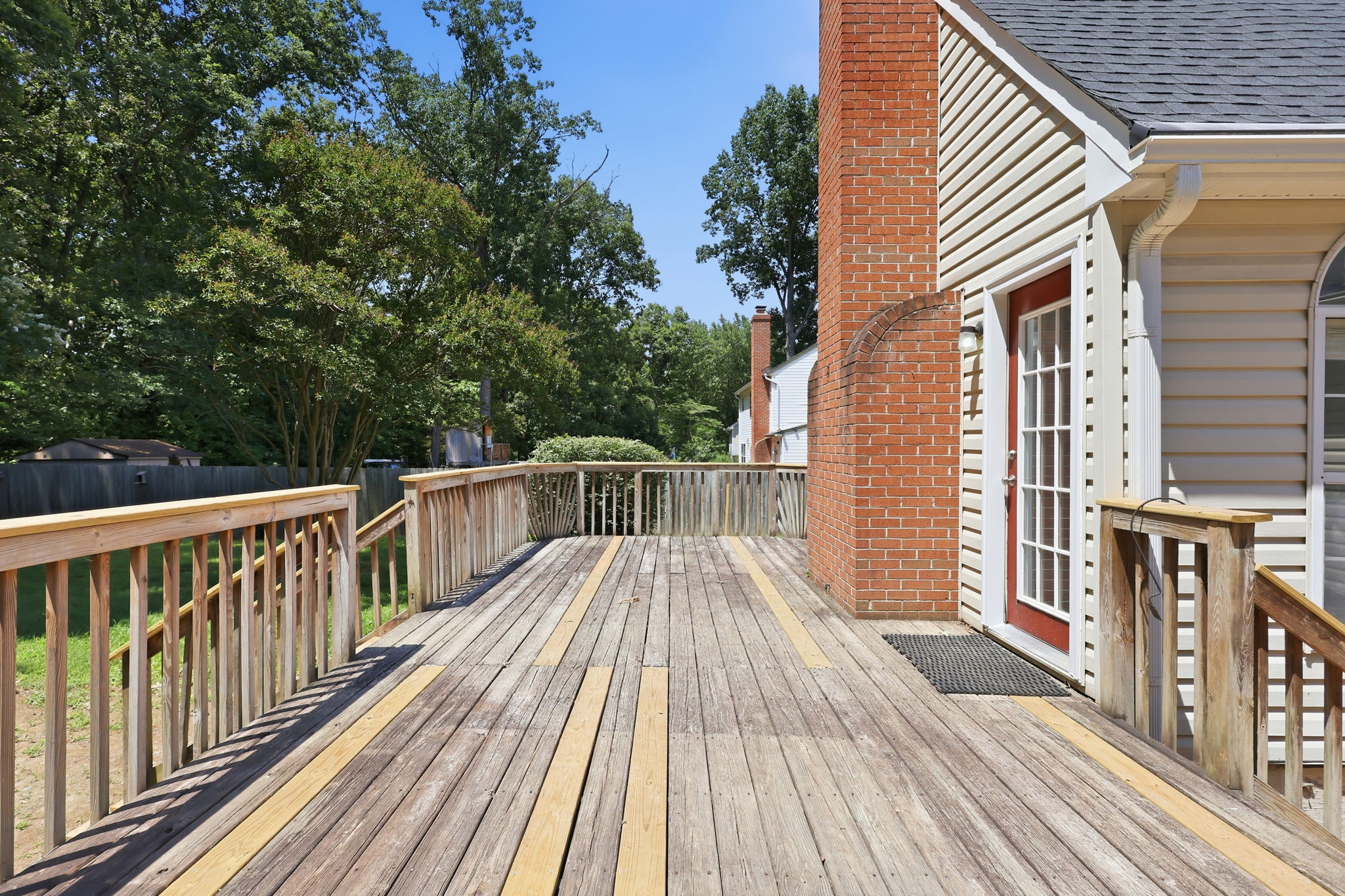 Large deck with secluded patio for the primary bedroom to the right