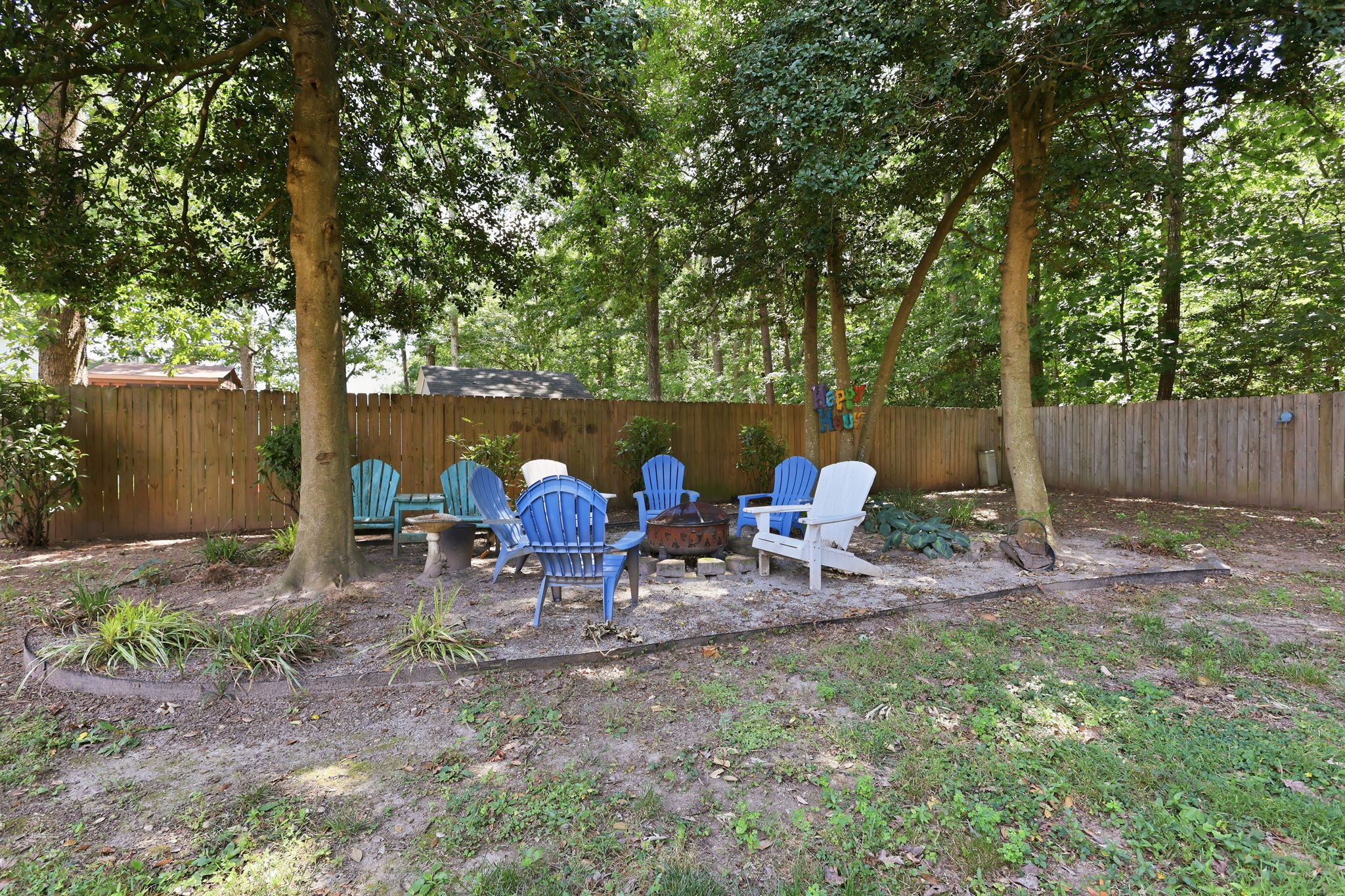 Gathering space with fire pit below trees