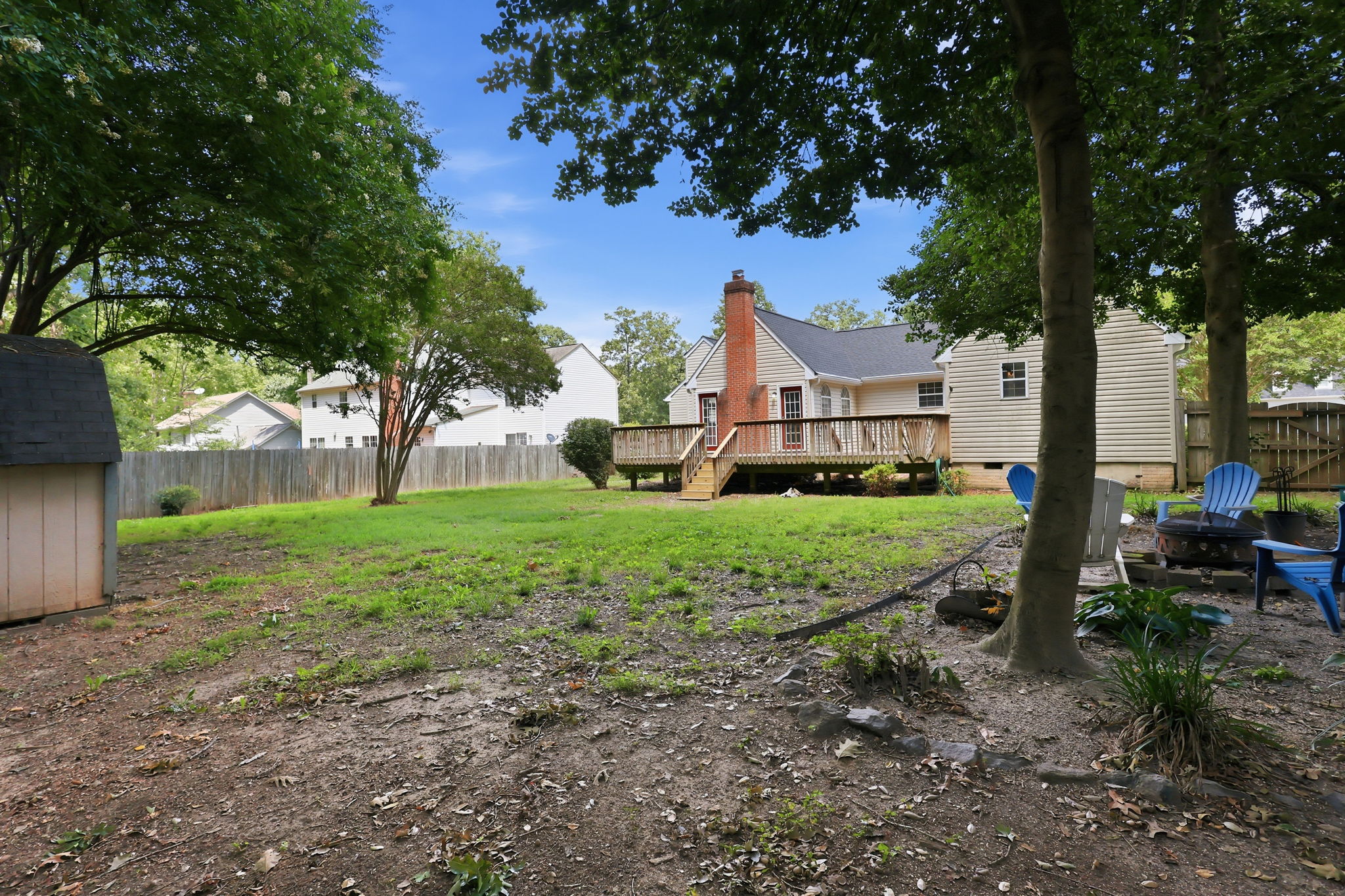Large, flat, and open back yard, beautifully shaded and space to entertain