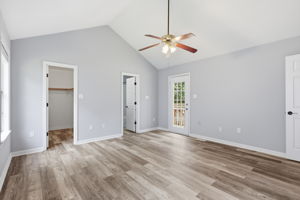 Primary Bedroom with view of closet, primary bath, and private entry to deck