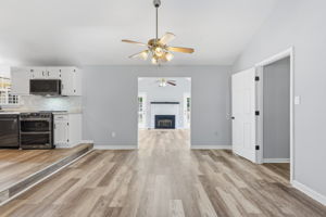 Dining room with view of elevated kitchen and sunroom