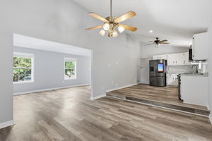 View of elevated kitchen, dining room, and living room