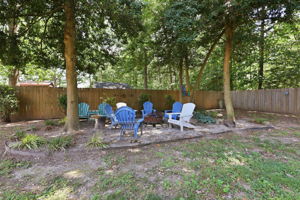Gathering space with fire pit below trees