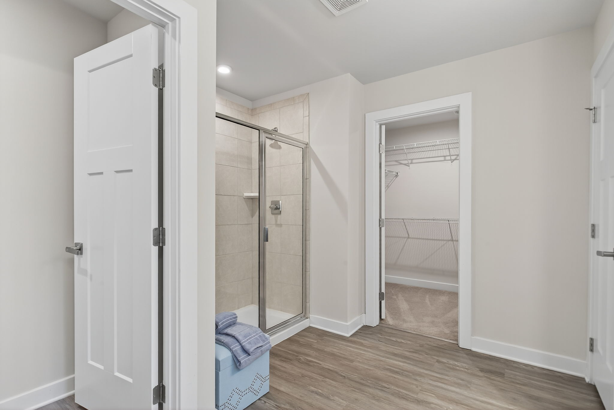 Separated water closet by a tiled walk-in shower