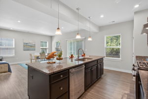 Center island with sink, dishwasher, and seating