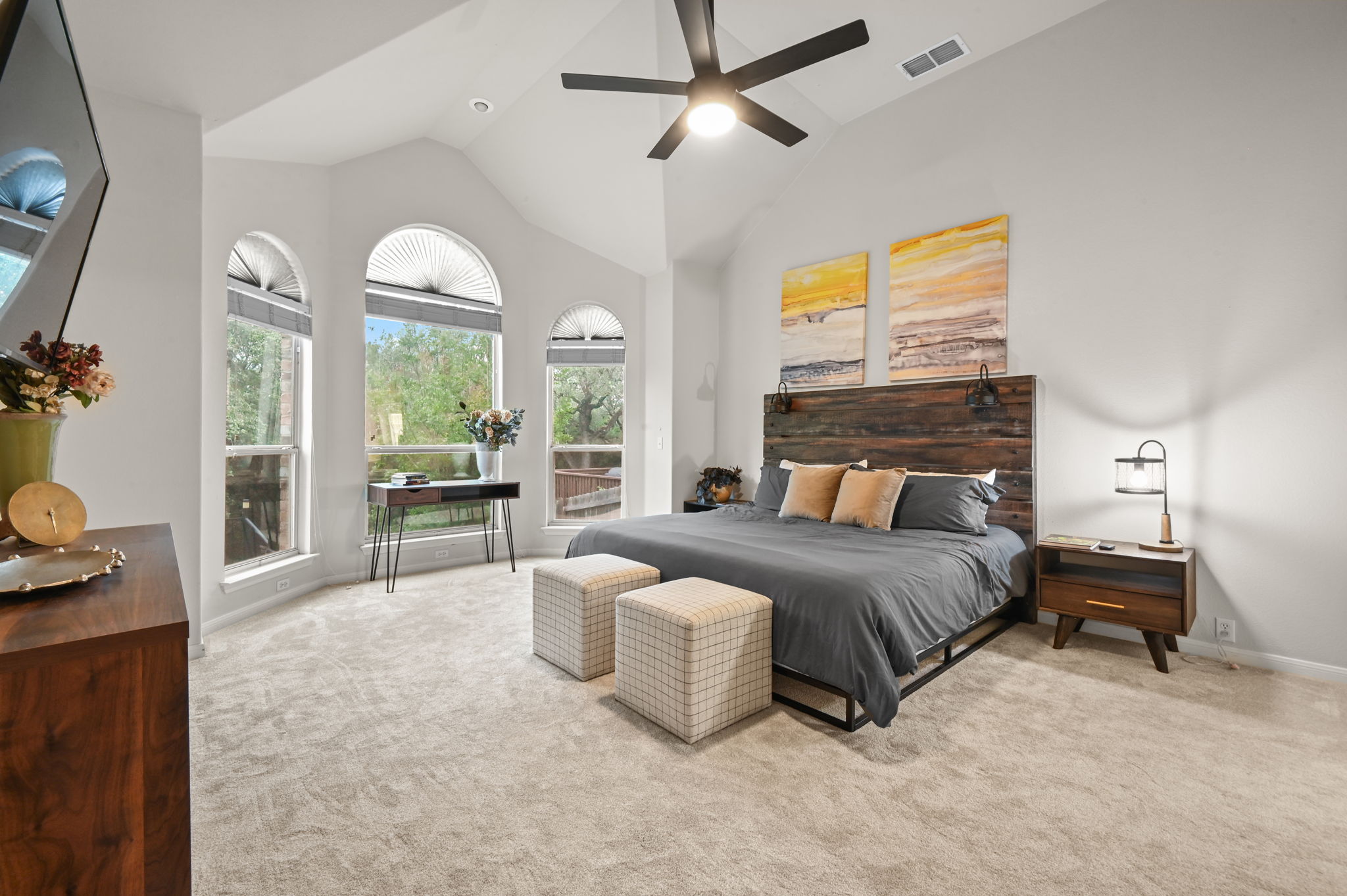 The primary bedroom is so serene. 12-foot ceilings and bay windows overlook the backyard and a ruby red Crepe Myrtle tree. New carpet was just installed. Opens to a large primary bath and huge walk-in closet.