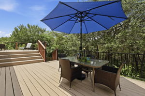 Right off the kitchen is the beautiful 2 story deck overlooking towering live oak trees, the backyard, and the woods backing to Slaughter Creek.