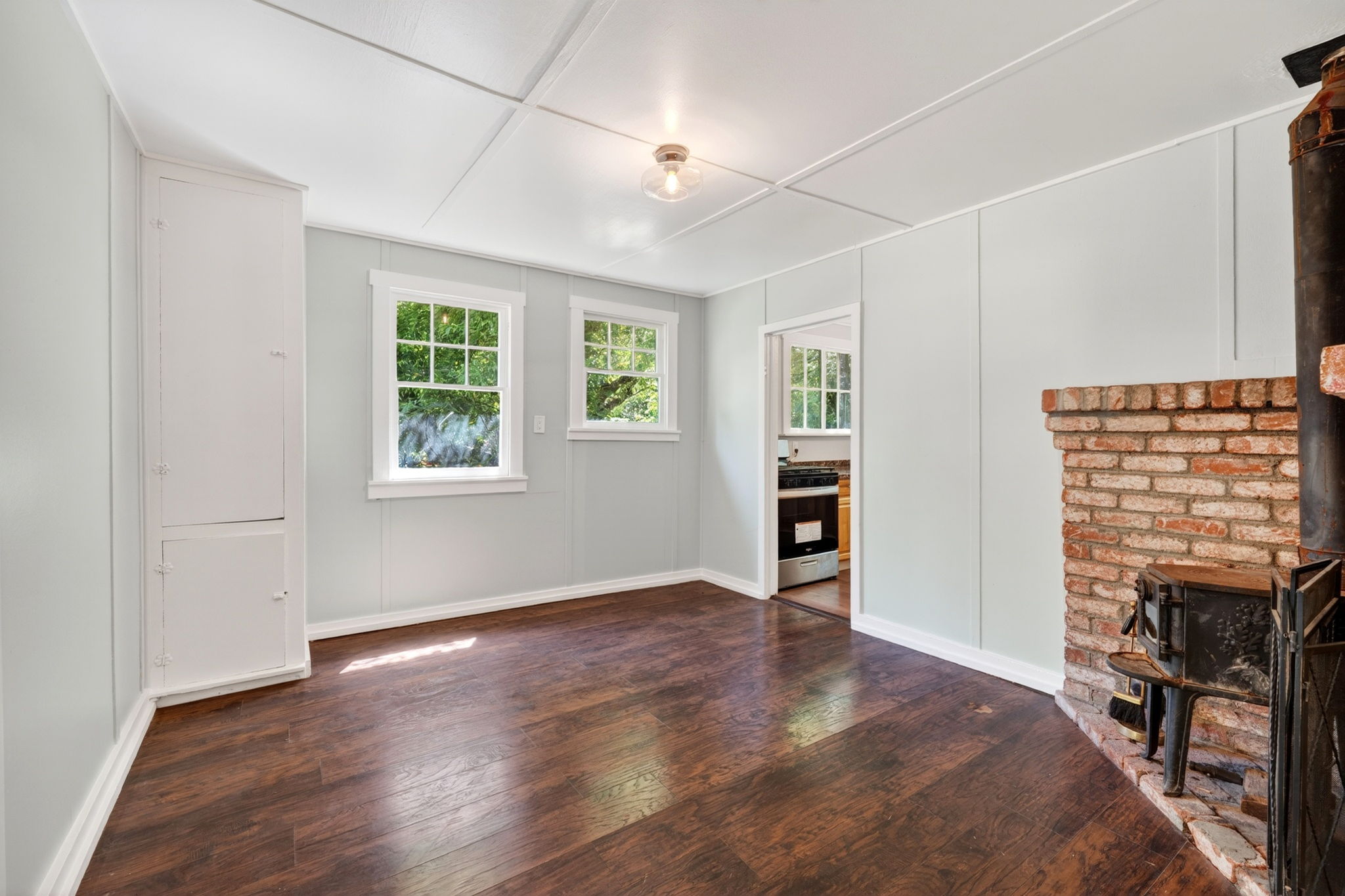The den with a California Cooler on the left and the kitchen to the right.