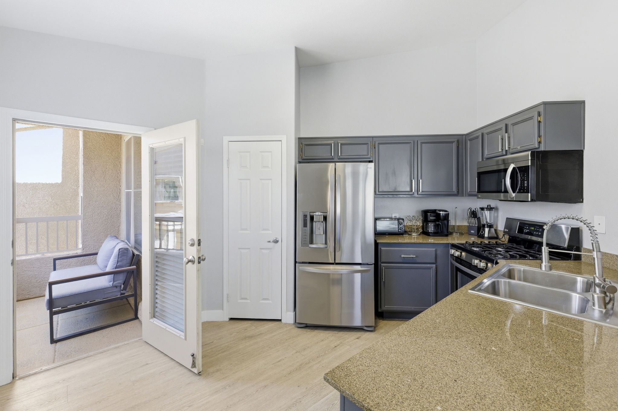 Well appointed kitchen flows to balcony.