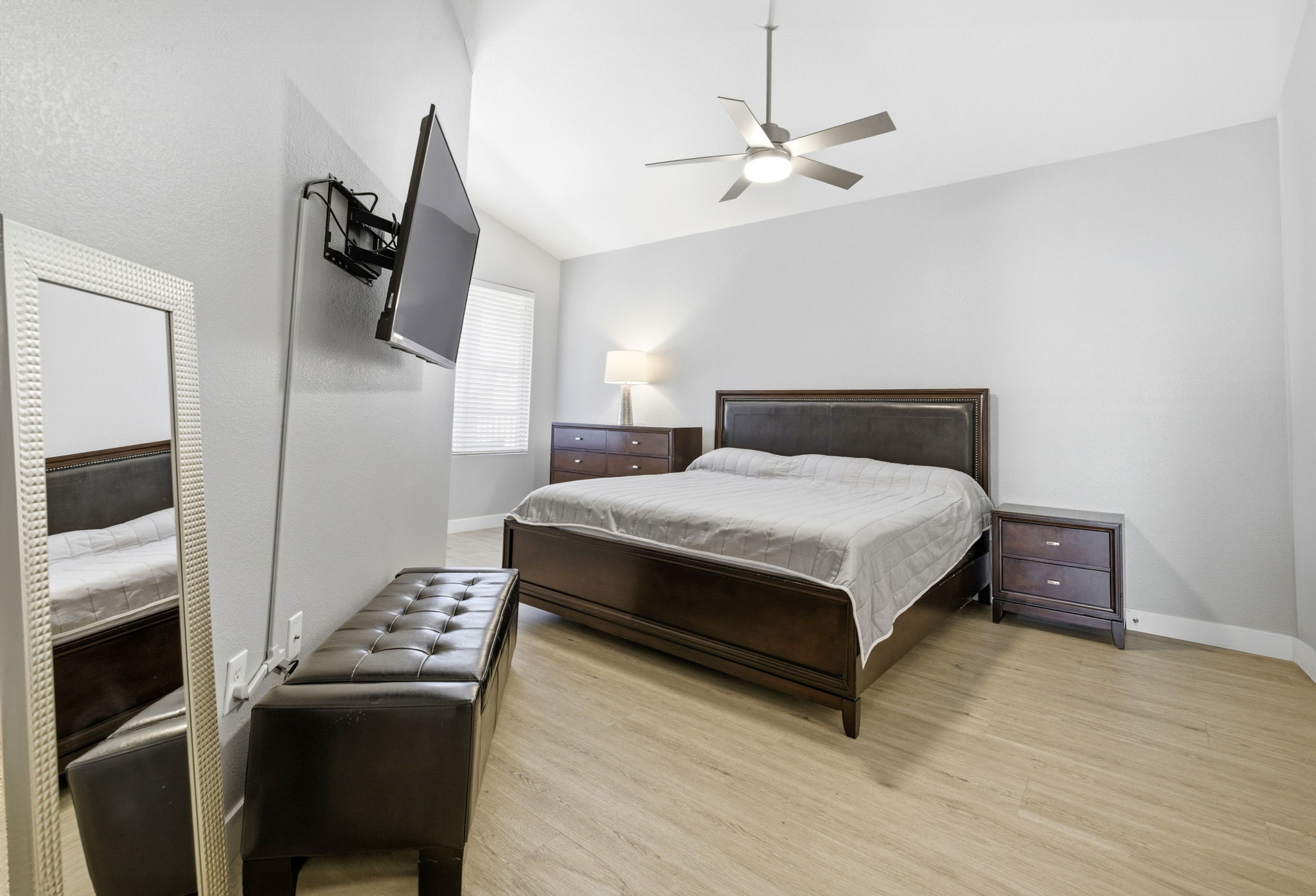 Primary bedroom with upgraded flooring & ceiling fan.
