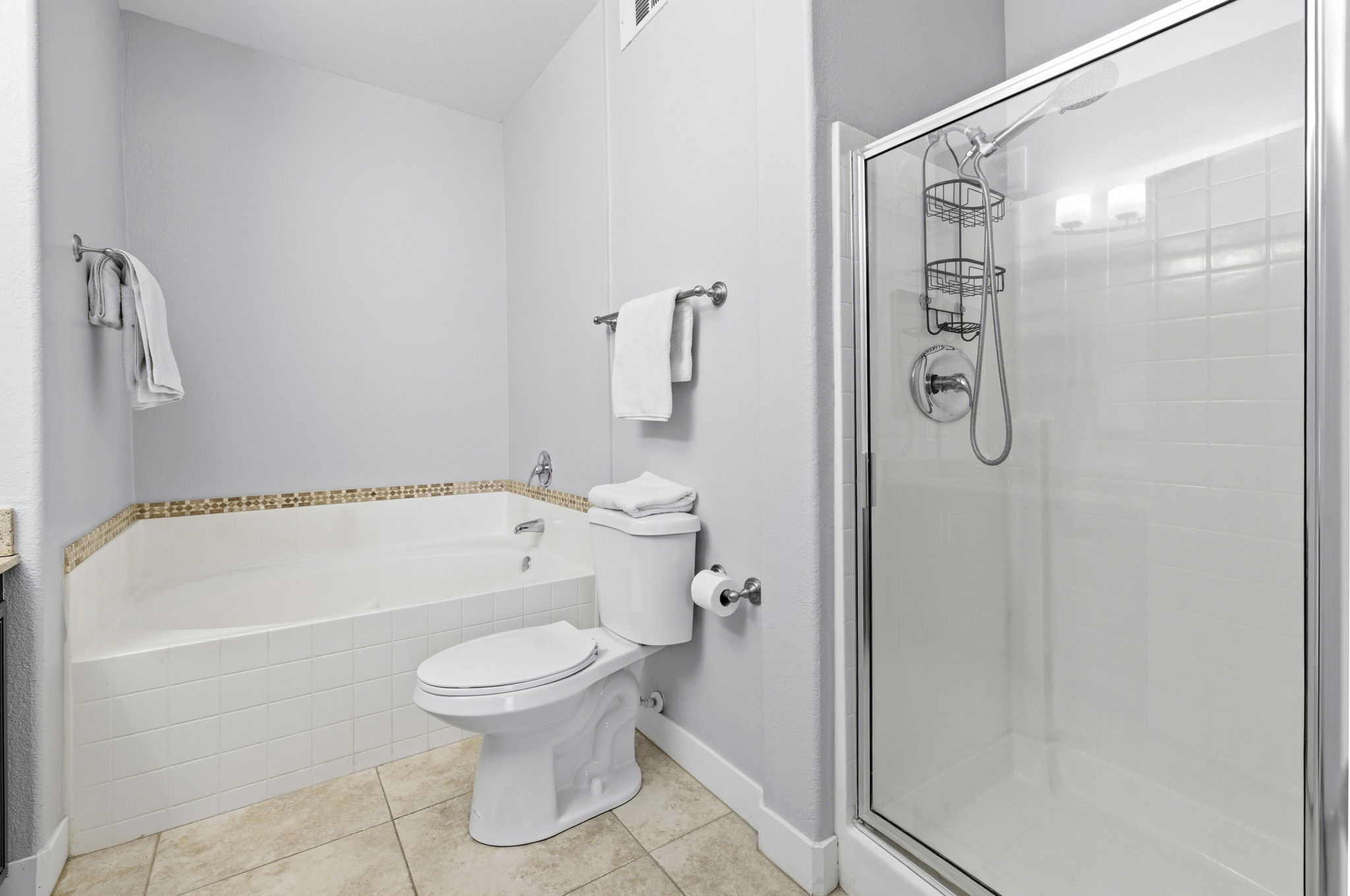 Primary bathroom with walk in shower & large tub.