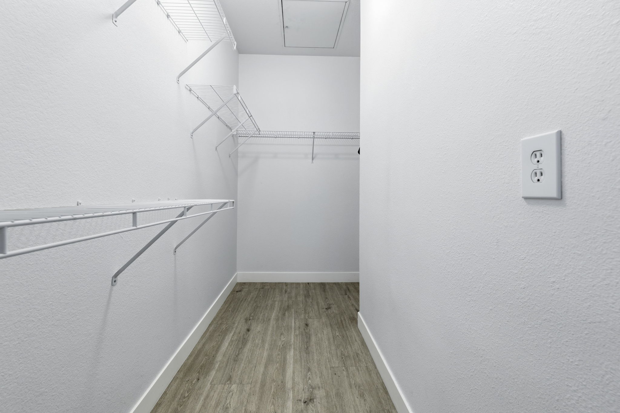 Voluminous walk-in closet in primary.