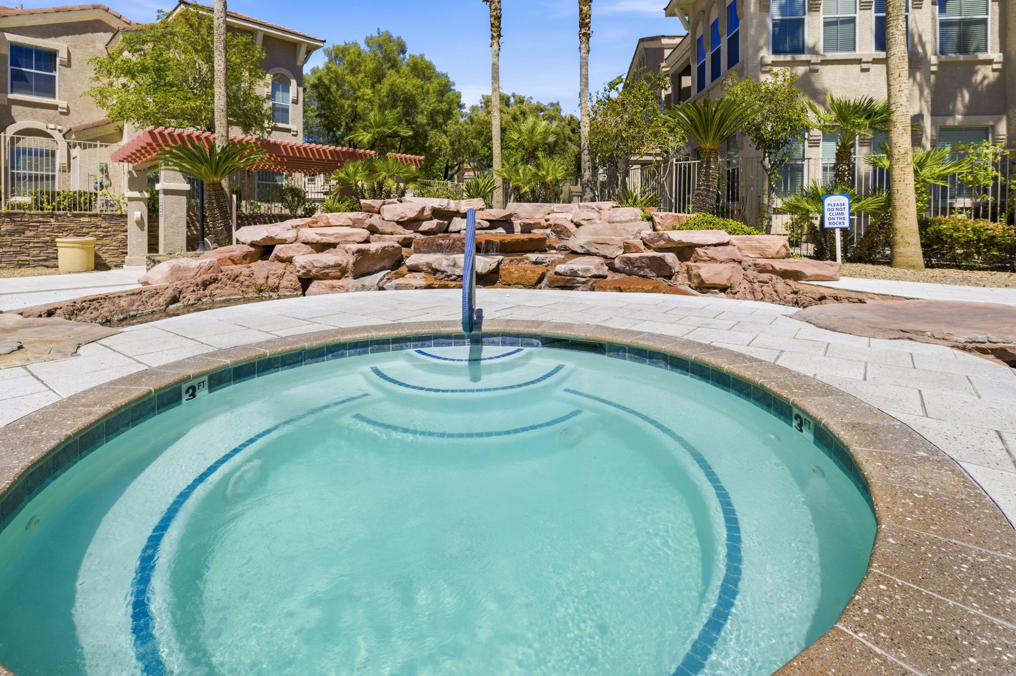 Waterfall landscaping behind hot tub.