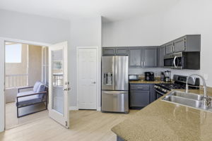 Well appointed kitchen flows to balcony.