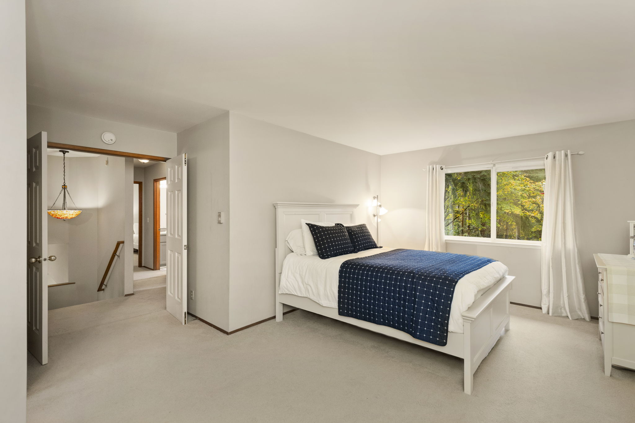 Another shot of primary bedroom with double doors.