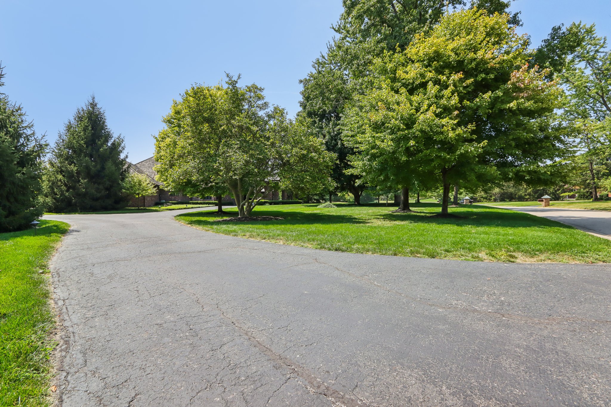 View from far side of driveway, house is on the left, road on the right