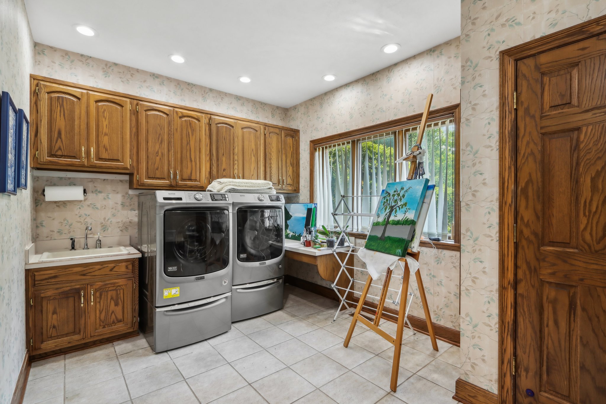 Laundry room- washer and dryer are included. Sink and wet closet also present