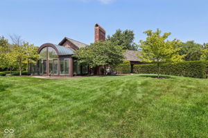 Back view of house/sunroom- grass virtually edited