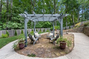 Pergola in Backyard by pond and Fountain