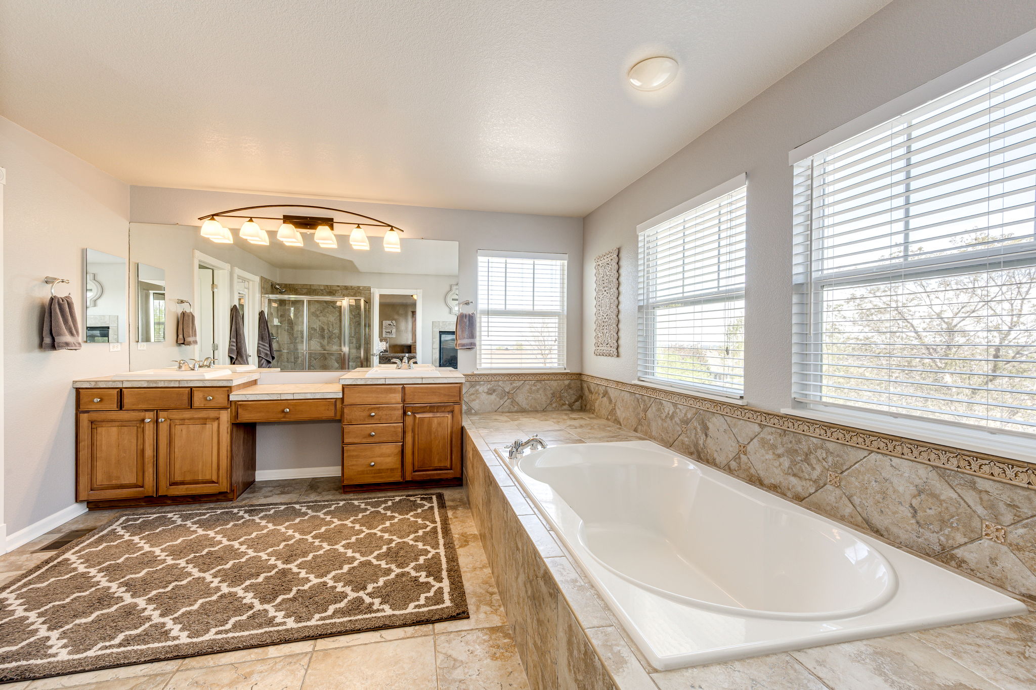 Ahh.. This Primary Bath Offers Double Sinks, Walk-In Shower & A Large Soaker Tub...